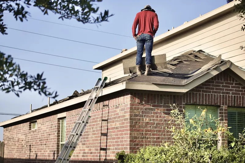 Professional roofer working on a residential roof in Leffingwell